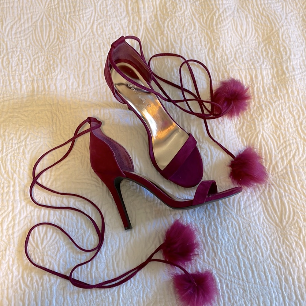 Size 6, fuchsia lace-up strappy heels. The lace-up straps have pom poms on ends.